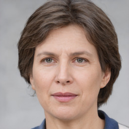 Joyful white adult female with medium  brown hair and grey eyes