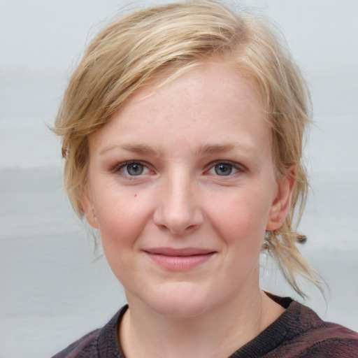 Joyful white young-adult female with medium  brown hair and blue eyes