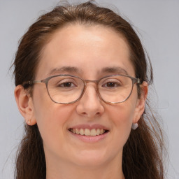 Joyful white adult female with medium  brown hair and brown eyes