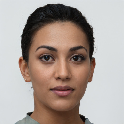 Joyful latino young-adult female with short  brown hair and brown eyes