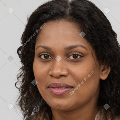 Joyful black young-adult female with long  brown hair and brown eyes