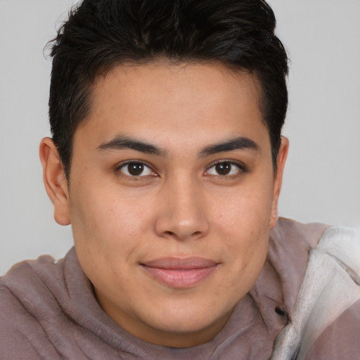 Joyful latino young-adult male with short  brown hair and brown eyes