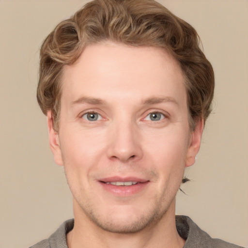 Joyful white adult male with short  brown hair and grey eyes