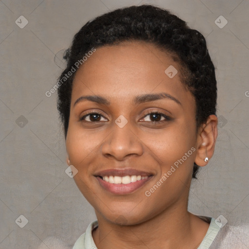 Joyful black young-adult female with short  brown hair and brown eyes