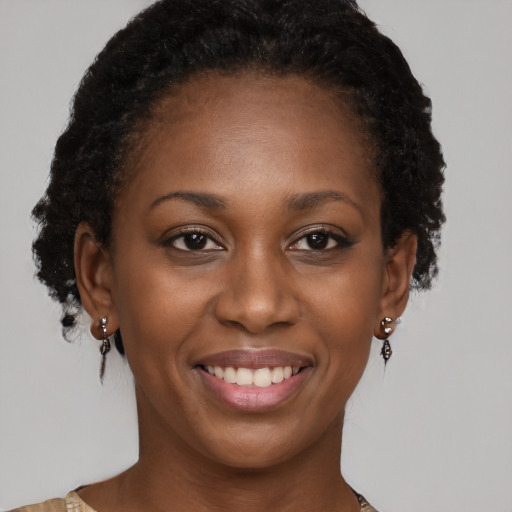 Joyful black young-adult female with medium  brown hair and brown eyes