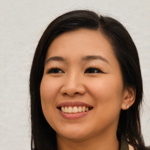Joyful asian young-adult female with long  brown hair and brown eyes