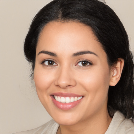 Joyful latino young-adult female with medium  black hair and brown eyes