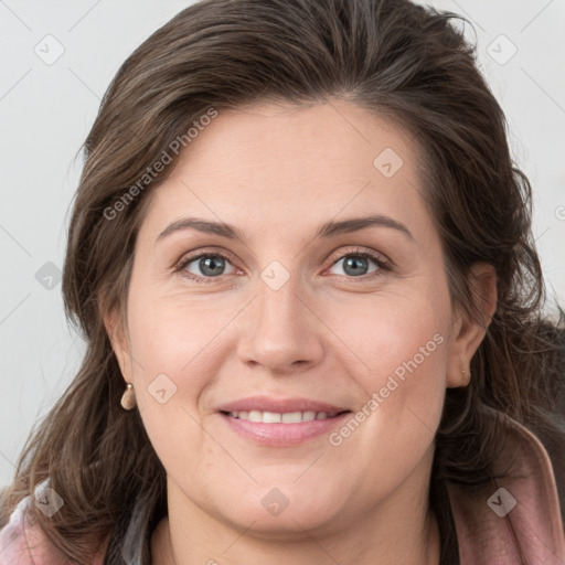 Joyful white adult female with medium  brown hair and grey eyes