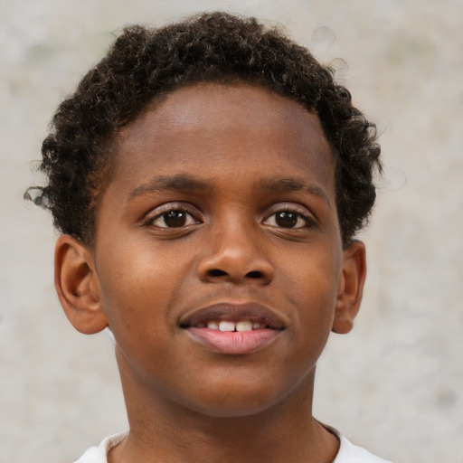 Joyful black child male with short  brown hair and brown eyes