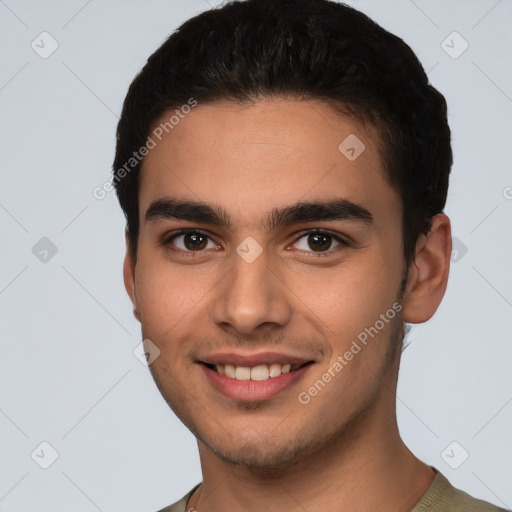 Joyful white young-adult male with short  black hair and brown eyes