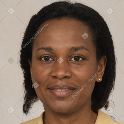 Joyful black adult female with medium  brown hair and brown eyes