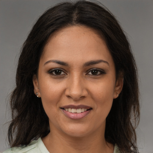Joyful latino young-adult female with medium  brown hair and brown eyes