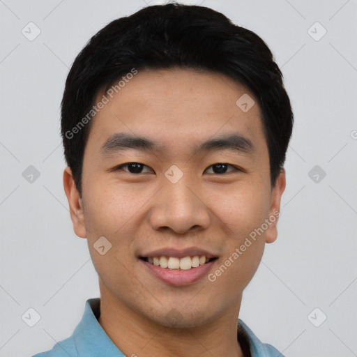 Joyful asian young-adult male with short  black hair and brown eyes