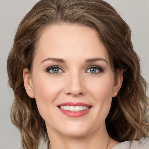 Joyful white young-adult female with medium  brown hair and grey eyes