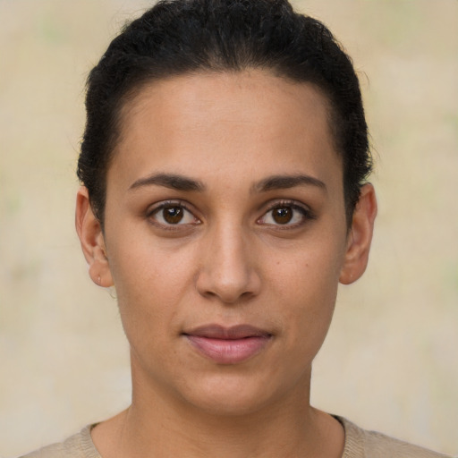 Joyful latino young-adult female with short  brown hair and brown eyes