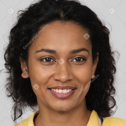 Joyful black young-adult female with long  brown hair and brown eyes