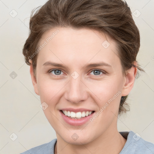 Joyful white young-adult female with short  brown hair and grey eyes