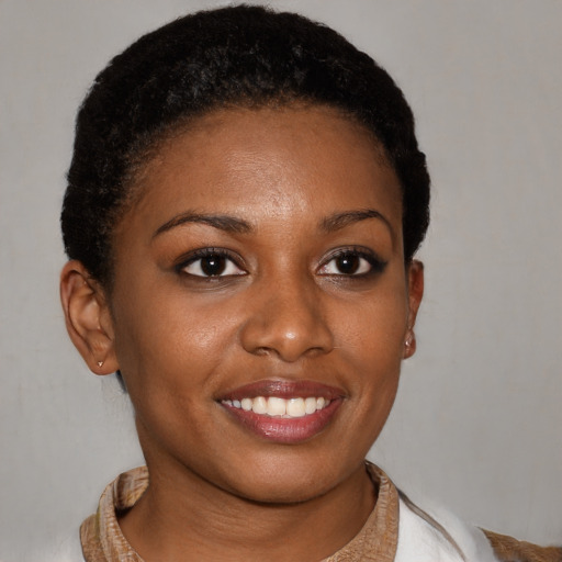 Joyful black young-adult female with short  brown hair and brown eyes