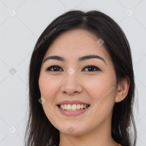 Joyful white young-adult female with long  brown hair and brown eyes