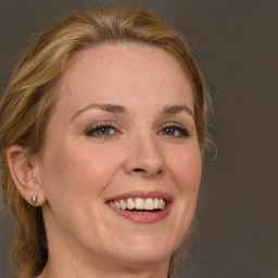 Joyful white adult female with long  brown hair and brown eyes