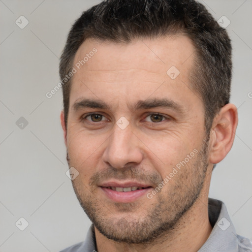 Joyful white adult male with short  brown hair and brown eyes