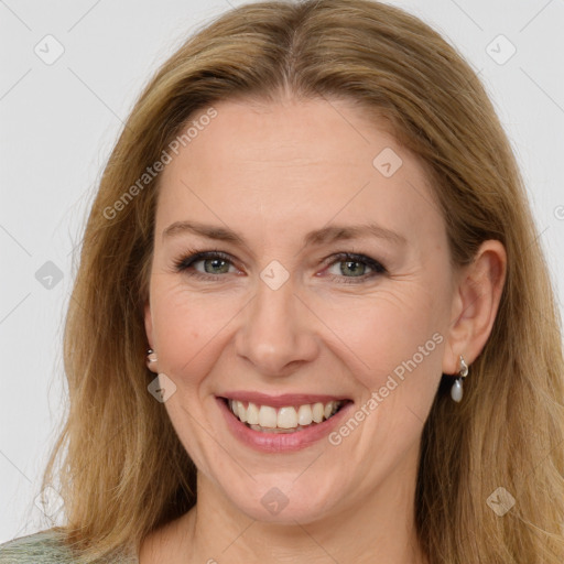 Joyful white adult female with long  brown hair and brown eyes