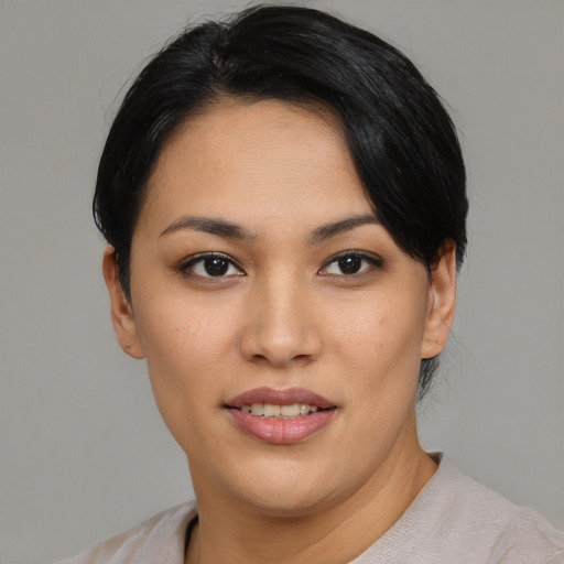 Joyful latino young-adult female with short  black hair and brown eyes