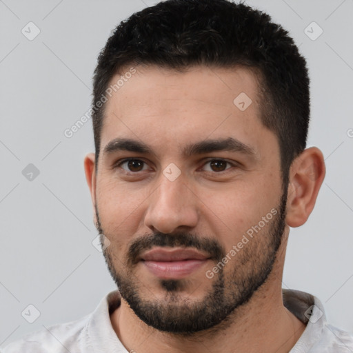 Joyful white young-adult male with short  black hair and brown eyes