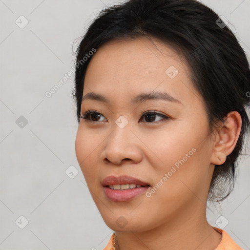 Joyful asian young-adult female with medium  black hair and brown eyes