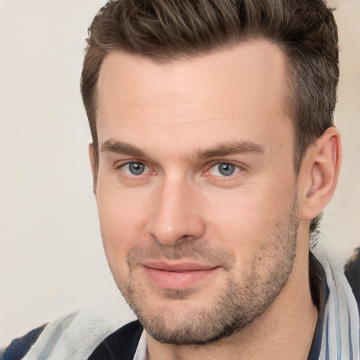 Joyful white adult male with short  brown hair and brown eyes