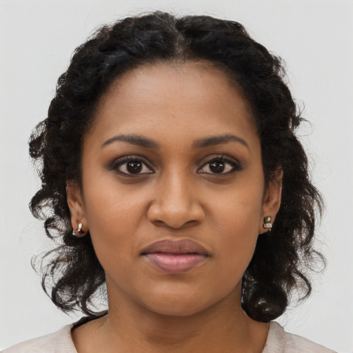 Joyful black young-adult female with medium  black hair and brown eyes