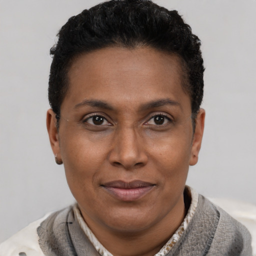 Joyful latino adult female with short  brown hair and brown eyes
