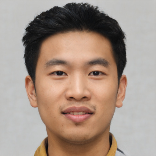 Joyful asian young-adult male with short  black hair and brown eyes