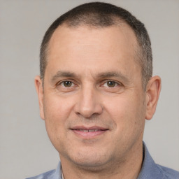 Joyful white adult male with short  brown hair and brown eyes