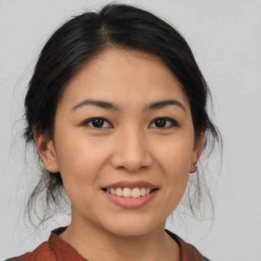 Joyful asian young-adult female with medium  brown hair and brown eyes