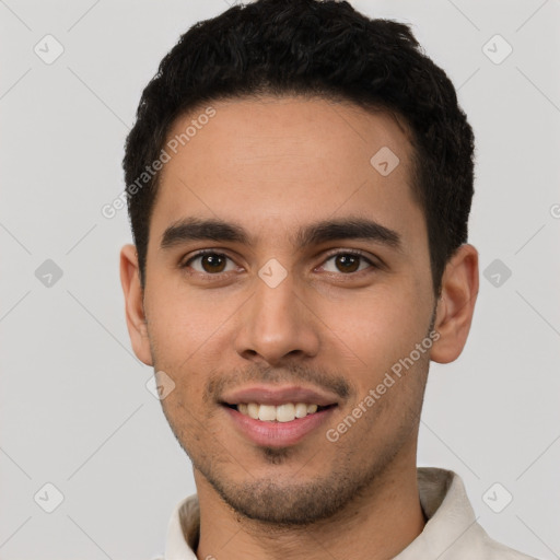 Joyful white young-adult male with short  black hair and brown eyes