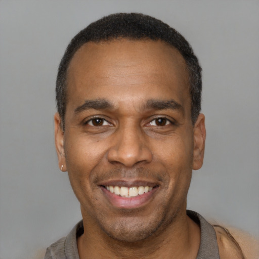Joyful latino adult male with short  black hair and brown eyes