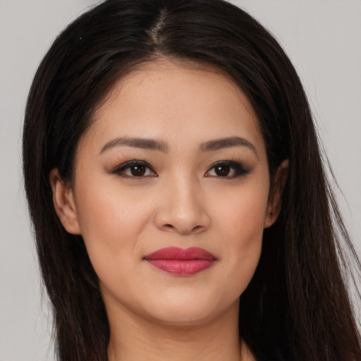 Joyful white young-adult female with long  brown hair and brown eyes