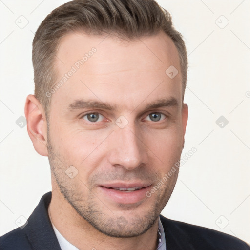 Joyful white young-adult male with short  brown hair and grey eyes