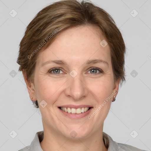 Joyful white adult female with medium  brown hair and grey eyes