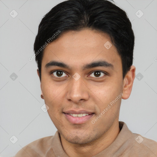 Joyful latino young-adult male with short  brown hair and brown eyes