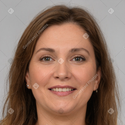 Joyful white adult female with long  brown hair and grey eyes