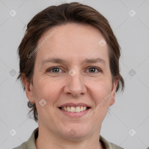 Joyful white adult female with medium  brown hair and grey eyes