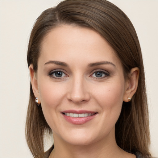 Joyful white young-adult female with long  brown hair and grey eyes