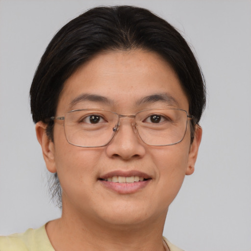 Joyful asian adult female with short  brown hair and brown eyes