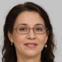 Joyful white adult female with long  brown hair and grey eyes