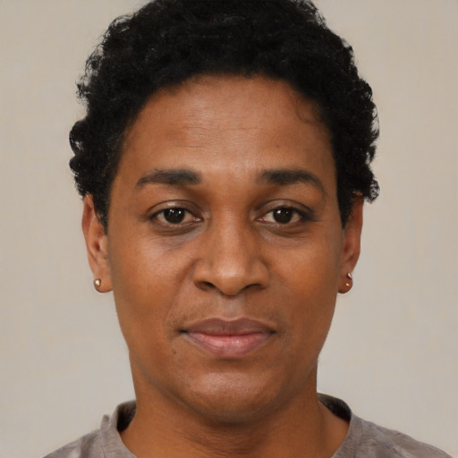 Joyful black young-adult female with short  black hair and brown eyes