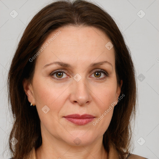 Joyful white adult female with long  brown hair and brown eyes