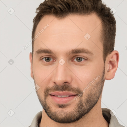 Joyful white young-adult male with short  brown hair and brown eyes