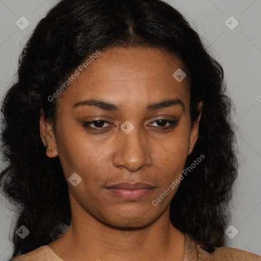 Joyful black young-adult female with long  brown hair and brown eyes